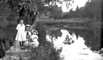 Woman and girls by pond